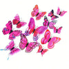 A set of twelve colorful, vibrant pink and orange 3D magnetic butterfly wall decor pieces.