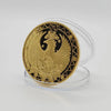 A round gold commemorative iron coin featuring an eagle with a crown and wreath, set in a clear plastic holder.