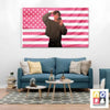 A wall tapestry featuring a pink and white striped flag with a person posing in front of it.