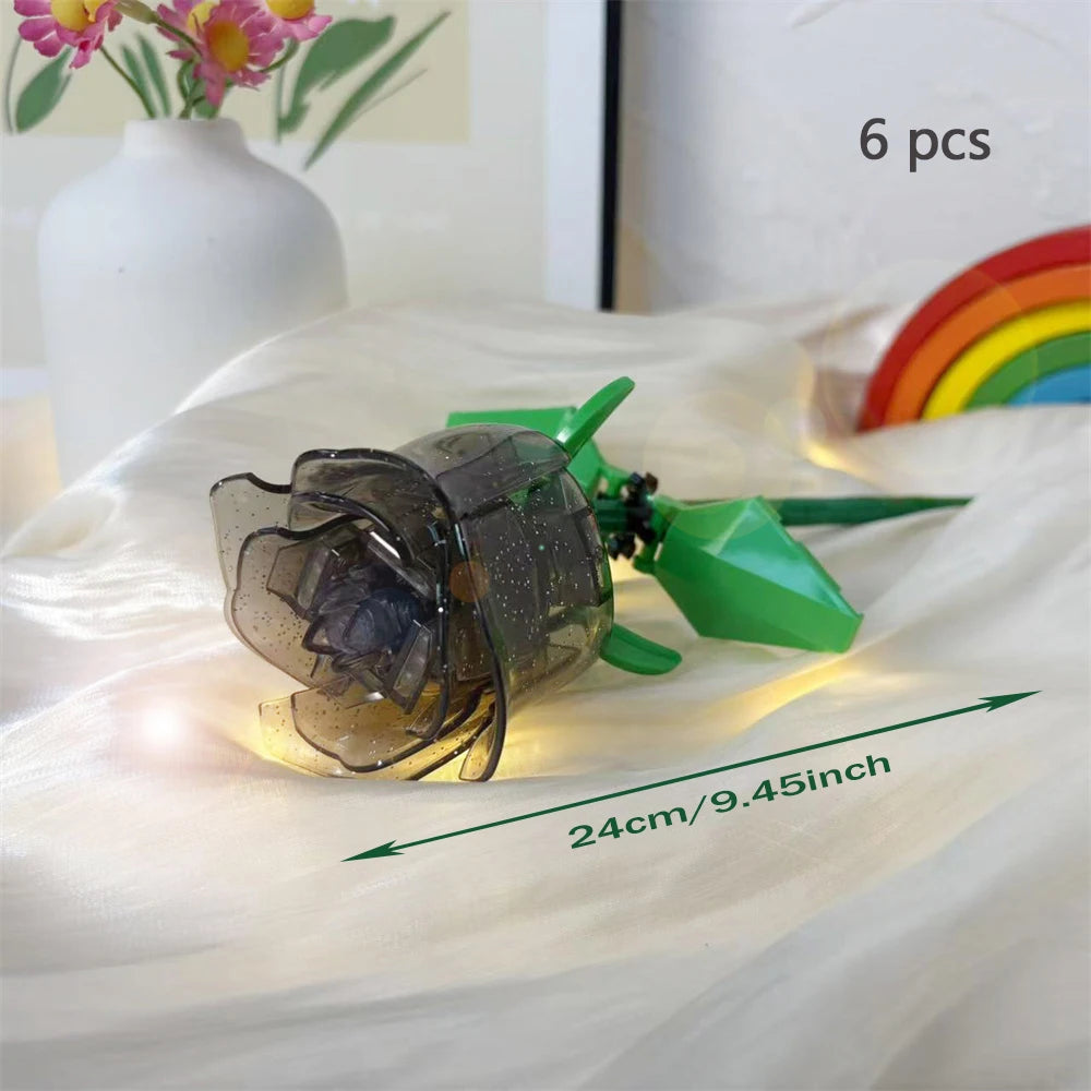 A clear glass rose flower building block bouquet with green stems and a rainbow background.