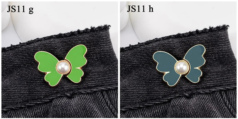 A close-up comparison of a green and a teal pearl butterfly waist tightener button on black denim jeans, labeled JS11 g and J