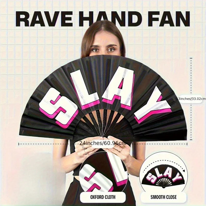 A woman holds open a black hand fan with the word SLAY printed on it, showing its size and smooth close feature.