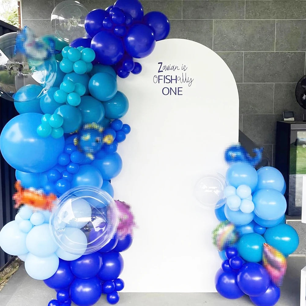 A colorful balloon arrangement featuring blue, pink, and purple latex balloons for a party theme.
