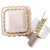 Gold and pink disposable party tableware set including plates, cups, napkins, and straws