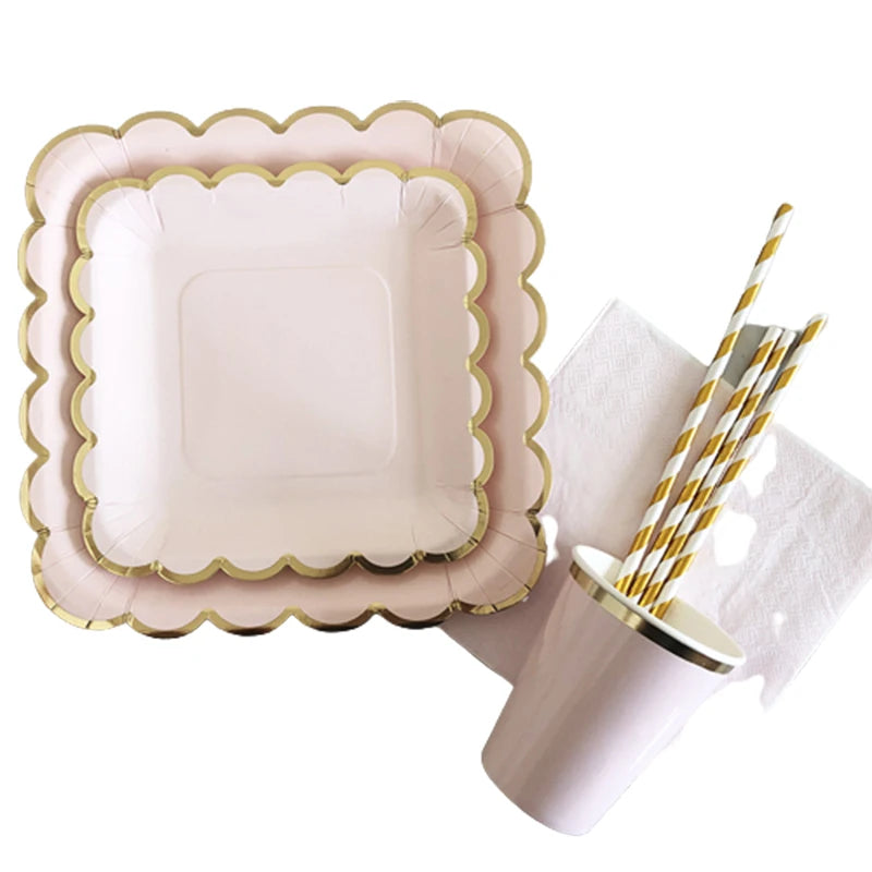 Gold and pink disposable party tableware set including plates, cups, napkins, and straws