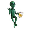 Resin green alien statue holding a glass of beer