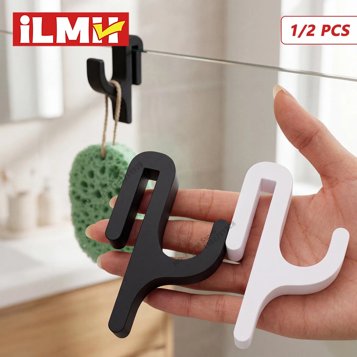 A hand holds two black and white 3D shower door towel hooks for hanging on glass doors.
