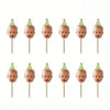 A set of twelve personalized baby photo cupcake toppers featuring infants on green and pink conical hats.