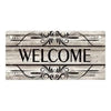 A rustic wooden hanging sign with the word WELCOME carved into the wood and decorated with ornamental lines.