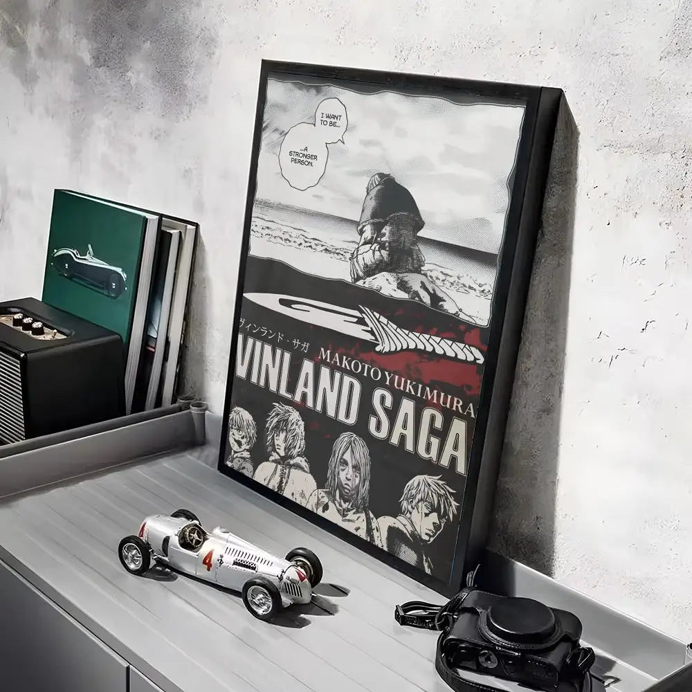 A framed poster of the Vinland Saga anime featuring a character, displayed on a shelf.