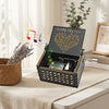 An antique wood music box with an engraved melody is displayed in a woven box on a light surface.
