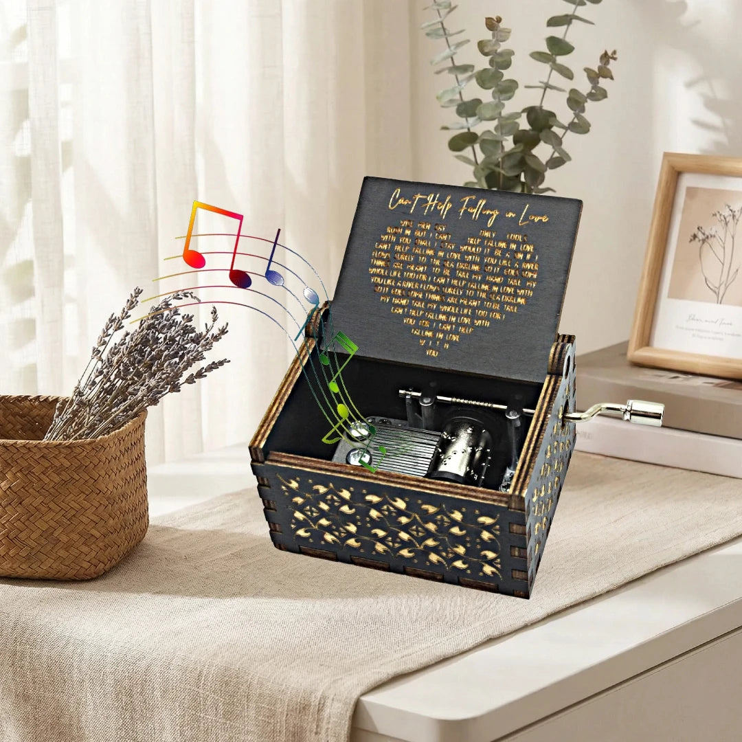 An antique wood music box with an engraved melody is displayed in a woven box on a light surface.