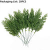 A bunch of green artificial Christmas berry stems with pine branches.