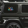 A close-up view of a black SUV with an automotive vinyl decal featuring the Autism awareness ribbon and the word AUTISM.