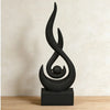 A black, stylized flame sculpture decor made of 3D printed material resting on a dark square base.