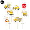 A set of seven construction vehicle cake toppers including an excavator, crane, and road signs.
