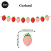 A string of pink strawberry-shaped decorations used for a garland or banner.