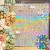 A vibrant glitter square wall backdrop featuring iridescent colors and a sparkly background for a party.