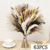 A bouquet of natural dried eucalyptus flowers featuring beige, brown, and white plumes and small yellow accents.