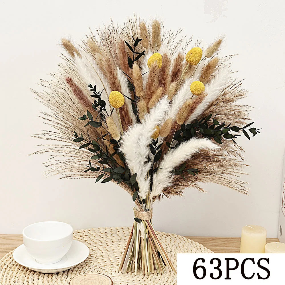 A bouquet of natural dried eucalyptus flowers featuring beige, brown, and white plumes and small yellow accents.