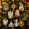 A close-up of Christmas diamond art ornaments hanging on a green fir tree.