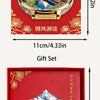 A red gift set featuring an embossed metal magnet of a Swiss cityscape and mountains, packaged in a box.