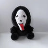 A black plush toy of Ghost Face with a white mask and a red tongue.
