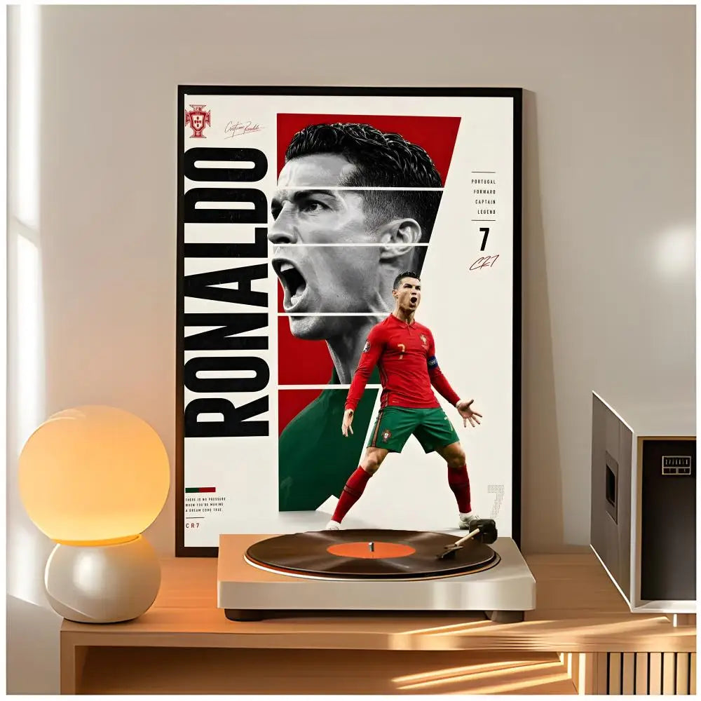 A framed poster of Cristiano Ronaldo featuring a close-up portrait and a full-body shot, displayed on a wooden surface.