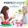 A young woman is presenting colorful fridge magnets to another young woman in a bright indoor setting.