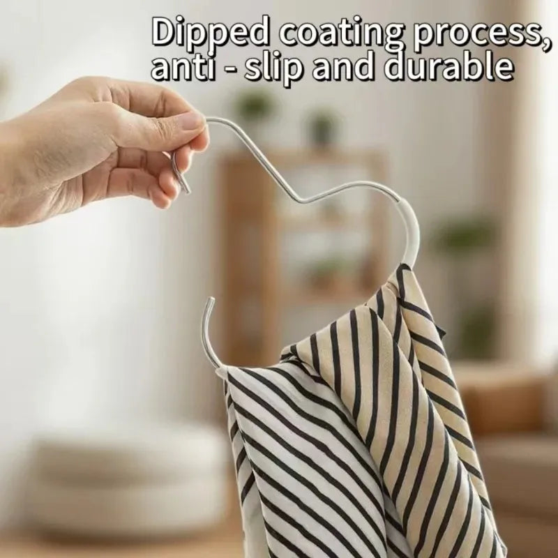 A hand is dipping a coating process onto a white wire hanger used for an 8-slot hat organizer rack.