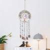 A hanging crystal tree of life sun catcher wall decor with a circular frame and dangling beads.