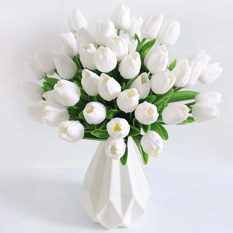 A bouquet of white artificial tulip flowers arranged in a white vase for home decor.