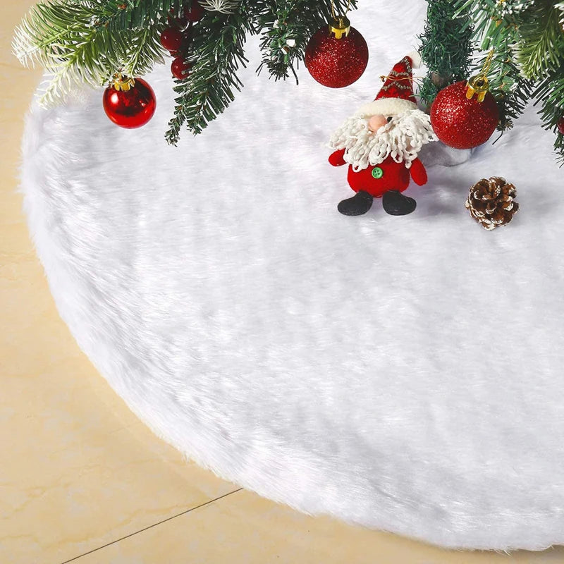 White plush Christmas tree skirt with a snowflake design decorated with red ornaments and pinecones.