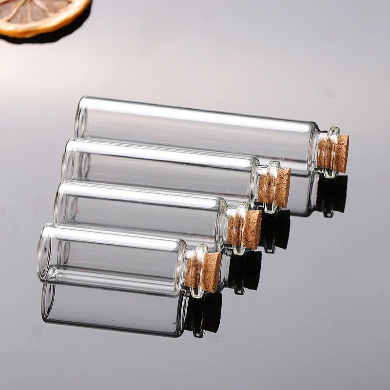 A row of clear glass cork stoppers with natural wood corks on the top, arranged diagonally.