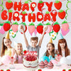 A colorful strawberry birthday party decoration set featuring banners, cake toppers, and cupcakes on a table.