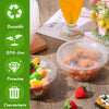 Clear disposable plastic bowls with lids containing food items on a wooden surface