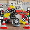 A display featuring a black number 2 balloon, various colored balloons, and a red race car model surrounded by traffic light 