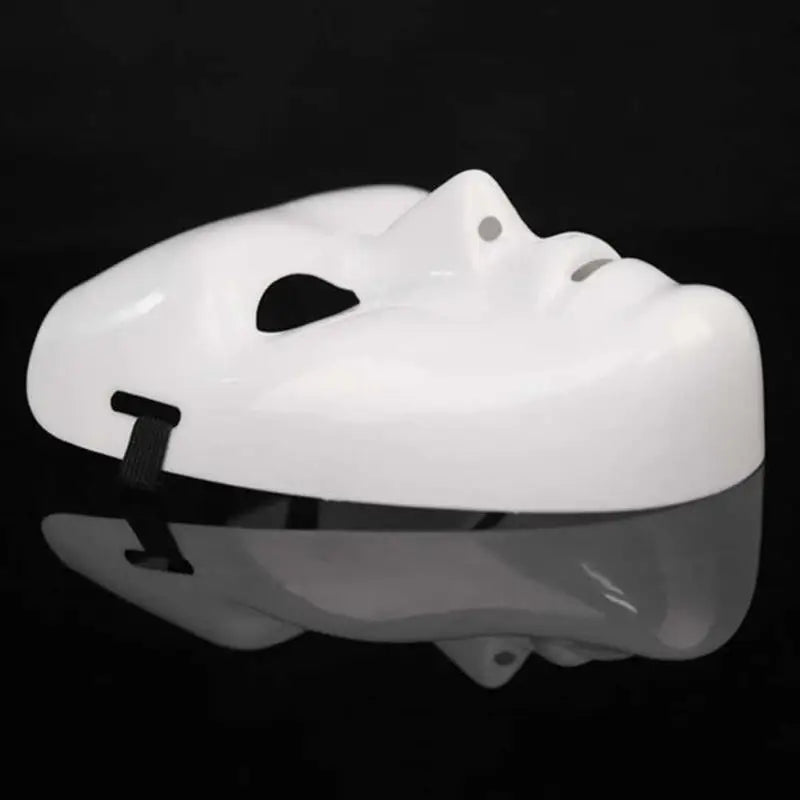 A white performance mask for dance or cosplay, shown from above with a reflective surface.