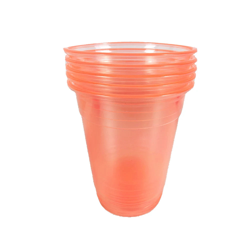 A stack of clear orange plastic party cups with a slightly translucent glow.