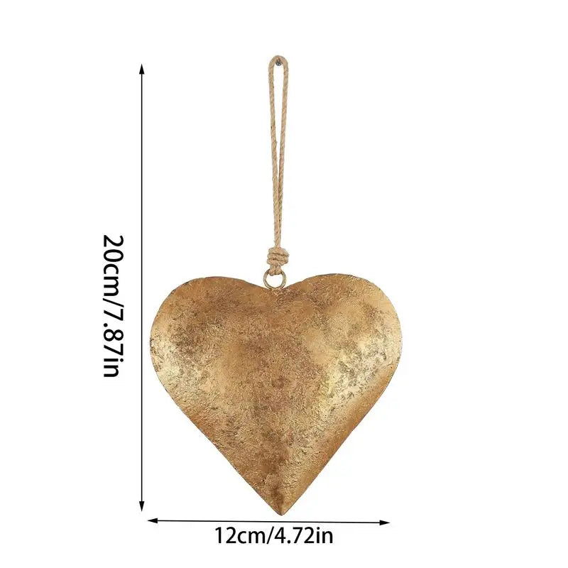 Antique golden metal heart wall decor with a natural twine hanging loop