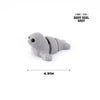 A grey baby seal figurine showing its side profile and texture.