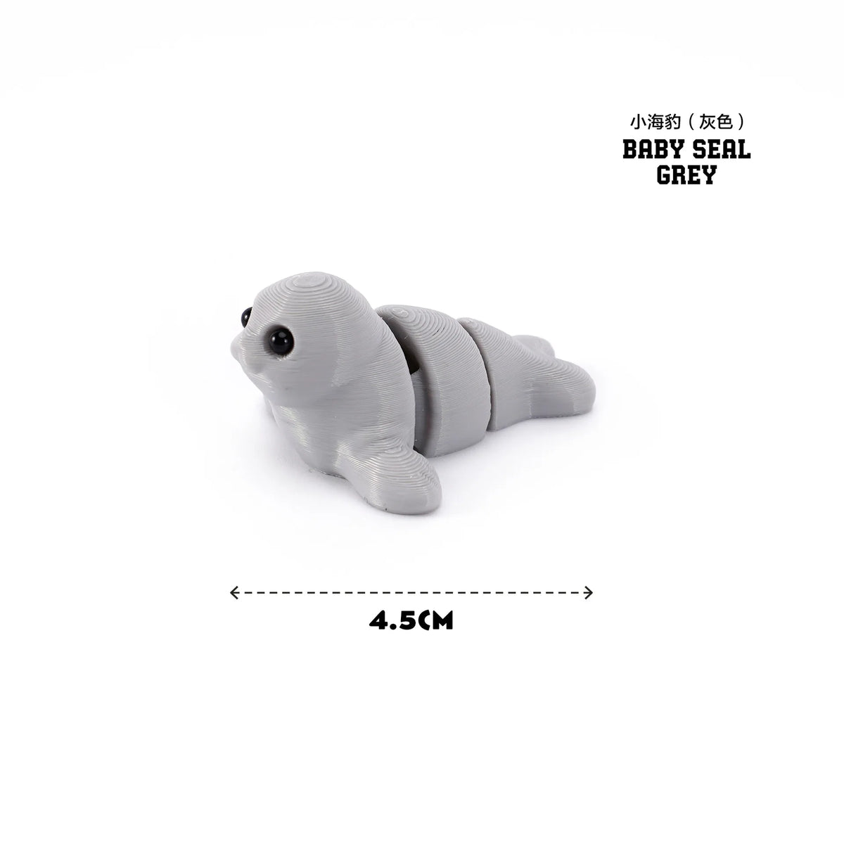 A grey baby seal figurine showing its side profile and texture.