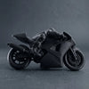 A black 3D printed racing motorcycle rider figurine used as desk decor.