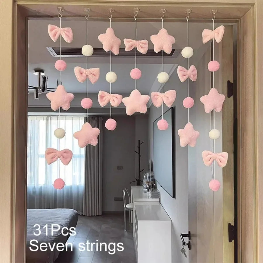 Pink tassel door curtain featuring heart and star shapes hanging from the door frame.