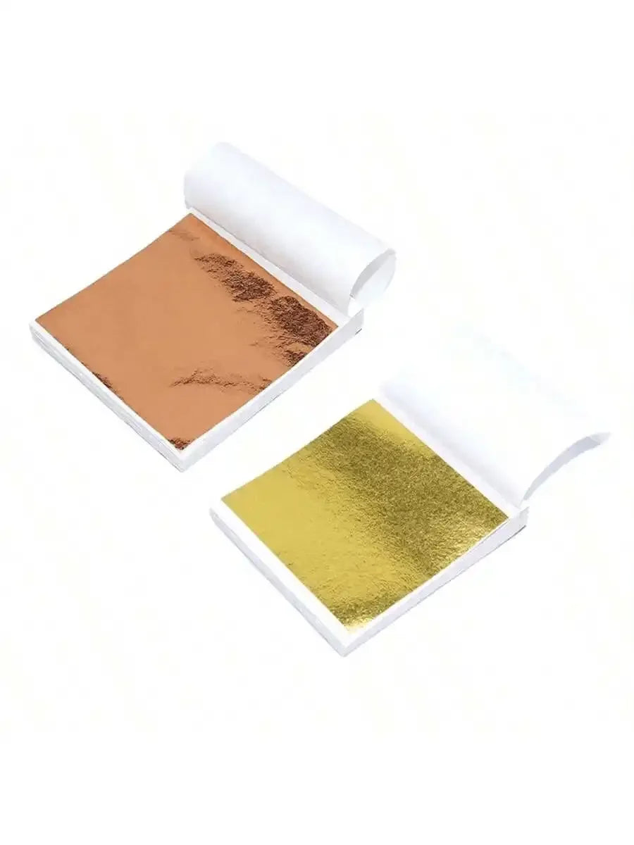 Open package of edible gold leaf flakes for baking and cake decoration showing a sheet of gold color.