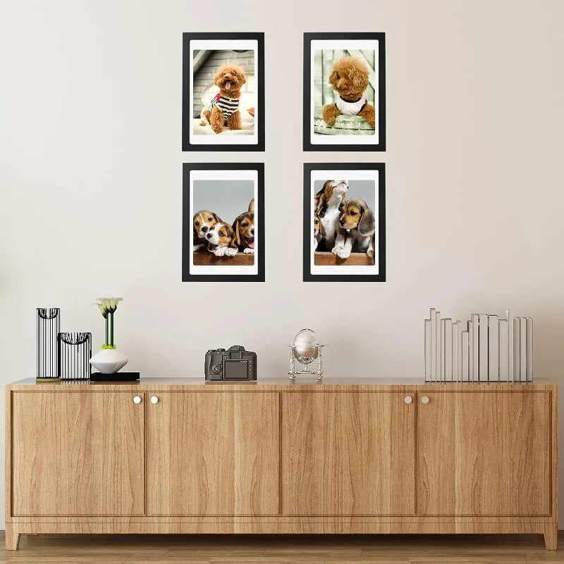 A set of five black wooden picture frames displaying photographs of golden retriever puppies for wall display.