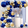 A balloon arch display featuring navy blue, gold, and white balloons arranged in a tiered structure.