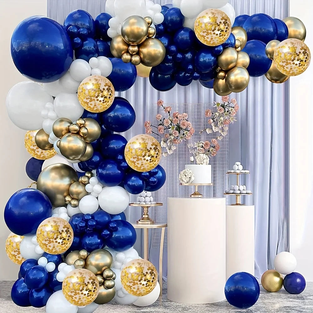 A balloon arch display featuring navy blue, gold, and white balloons arranged in a tiered structure.