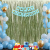 A birthday banner made of light blue paper flags hangs in front of a green wavy curtain backdrop decorated with balloons and 
