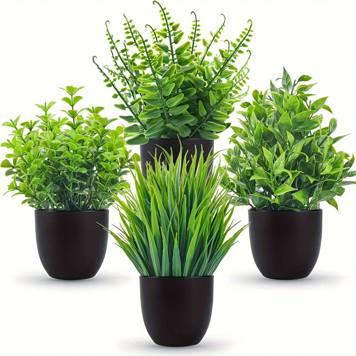 A set of four small artificial bonsai plants in various shades of green potted in black containers.
